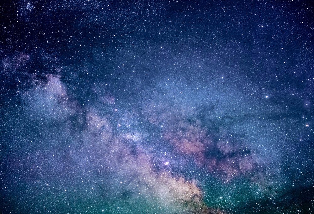 A view of the galaxy with stars and colourful clouds in space